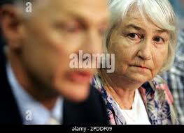 Carol Patton, right, mother of murdered women Janelle Patton, watches  Australian Federal Police officer Sergeant Bob Peters speak at a press  conference in Sydney, Australia, Wednesday, Feb. 1, 2006, following the  arrest
