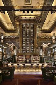 Art Deco Inspired Atlas Bar Features A Towering Central Liquor Tower That Reaches The Ceiling Located In The Parkview Square Building In Singapore Bar Design Restaurant Interior Deco Art Deco Bar