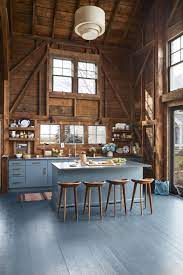 Dark floors, a dark huge island and antique white kitchen cabinets, countertop is granite which has gray in it and white and black for instance, this room features a lovely gray painted wooden floor that perfectly matches the dining chairs and provides a lighter counterpoint to the dark blue walls. 18 Best Painted Floors Painting A Floor Ideas