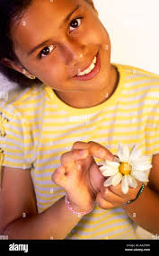 Young Girl Picking Daisy Petals Stock Photo