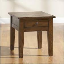 The table rests on a pedestal base and is marked with a identifying label to the underside. Broyhill Furniture Attic Heirlooms Rustic Oak End Tables