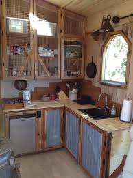 A One Of A Kind Tiny House Packed With Rustic Chic Design Finishes Tiny House Kitchen Rustic Kitchen Cabinets Rustic House