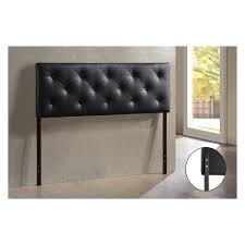 A black leather wingback tufted headboard and a dark stained nightstand add drama to the neutral bedroom. Full Baltimore Faux Leather Upholstered Headboard Black Baxton Studio Target