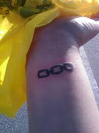 Grey ink motorcycle chain tattoo on left wrist. Chain Wrist Tattoo