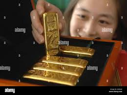 CHINA TAKES GOLD Gold bars have been created to mark the beginning of the  2008 Beijing Olympic Games, in China. The final bar Stock Photo