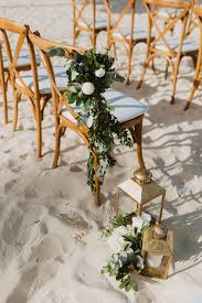 Beach Wedding Chair Corsages For The Aisle Walkway Wedding Chairs Floral Arrangements Wedding Gold Lanterns