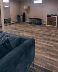 Engineered hardwood flooring is another option for those who want a beautiful hardwood floor look in their basement. Jess Kirby Basement Renovation Makeover Home Depot Winterton Oak Flooring 04248 Jess Ann Kirby