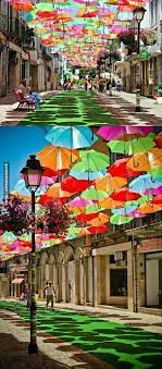 umbrellas street portugal colorful places beautiful places umbrella street