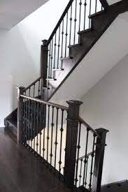 Stairs with banisters aren't ideal to wall mount a baby gate. Totally Transformed Townhouse Staircase Remodel Stairs Banister Remodel