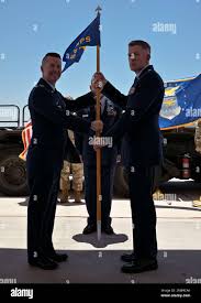 U.S. Air Force Lt. Col. Wade Parks, left, 50th Aerial Port Squadron  outgoing commander, relinquishes command to Maj. Edward Bobbett, during the  50th APS change of command ceremony at March Air Reserve