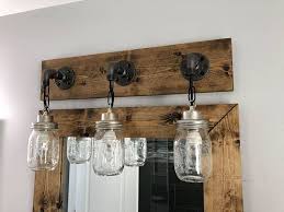 Each jar carries its own history and can vary in 'age' marks, brand, graphics and more while showing off the original wire bales. Dark Walnut Vanity Light Fixture Country Style Mason Jar Etsy Vanity Light Fixtures Mason Jar Lighting Jar Lights