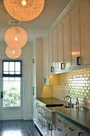 Long Butler S Pantry Is Dotted With Hemp Light Pendants Illuminating Ivory Cabinets Paired With Honed Pantry Lighting Farmhouse Pantry Farmhouse Kitchen Colors