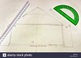 Rough Sketch Of House Floor Plans On Grid Paper With Green Ruler