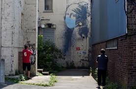 This opens in a new window. Banksy S Girl With A Pierced Eardrum Gains A Coronavirus Face Mask