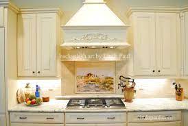 Beautiful italian tile backsplash mural of a kitchen window featuring a still life of olive tiles, grapes, bread, cheese, garlic, olive oil, olives, rosemary, lemons and a hummingbird by american artist linda paul. Tuscan Tile Murals Kitchen Backsplashes Tuscany Art Tiles