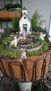 Miniature Fairy Garden In Awe Two Girl Fairies Who Are In Awe Of The Blessed Mother And Baby Statue At The Ch Fairy Garden Miniature Garden Fairy Garden Diy