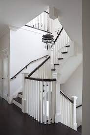 White and brown stair railing. White Staircase With Brown Hand Rail Transitional Entrance Foyer White Staircase Black Staircase White Stairs