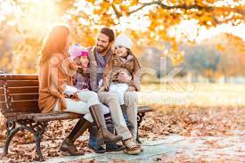 Smiling Family Spending Their Autumn Day In Nature And Communicating Fall Family Pictures Fall Family Photos Family Photoshoot Poses
