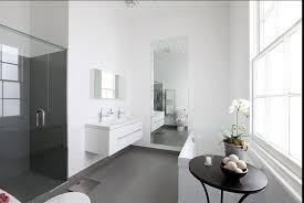 It features a charcoal grey accent rather than the traditional black that we most often see. White Walls Grey Floors In The Bathroom Grey Flooring Grey Walls White Trim Grey Floor Tiles