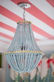 Upcycle A Plain Chandelier Into A Beaded Showpiece Wood Bead Chandelier Diy Chandelier Beaded Chandelier