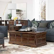 My coffee table is a big old wooden shipping crate, with wonderful texture and rustic details like. Solid Rustic Reclaimed Wood Storage Trunk Coffee Table