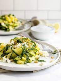 Raw Zucchini Salad Marinated In A Delicious Blend Of Fresh Lemon Juice Garlic And Salt Then Topped Wit Raw Zucchini Salad Zucchini Salad Healthy Salad Recipes