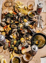 Clam chowder served in a bowl of bread is always a fantastic idea. Grilled Summer Clambake With Herbed Garlic Butter Edible Boston