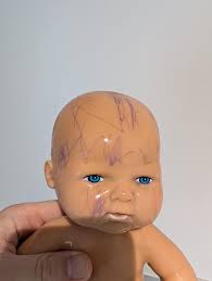 How to clean pen off my wife's childhood doll? : r/howto