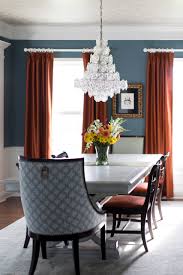 Another wall contains a series of white trimmed mirrors, and the centerpiece of the design is a lovely light fixture hanging above the dining table. Before After The Colorful Contemporary Dining Room Eclectic Interiors