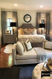This Master Bedroom Is Complete With Geometric Wallpaper A Loveseat And Plush Throw Pillows Making It Both Comfortable And Livable Home Decor Home Room