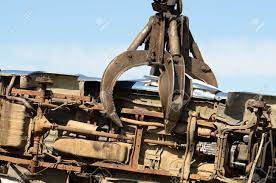 Large Excavator With A Claw Crushing And Piling Old Cars At A Stock Photo Picture And Royalty Free Image Image 14025896
