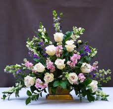 Keep rustic decor simple with a spray of flowers on the altar and warm, natural lighting with candles interspersed throughout the church. Classic Triangle Church Flower Arrangement Flower Magazine