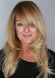 These bangs frame the model's face nicely and complement her glasses. Beach Blonde Wispy Layers With High Crown Long Layered Haircuts With Bangs Askhairstyles