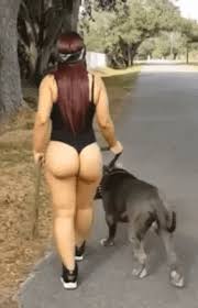 Curvy ass girl walking with a dog
