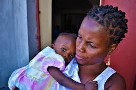 Haitian woman with child at Vaccination Clinic, 2018 (Photo by Rod Harmon) 