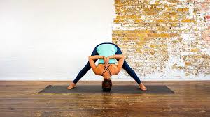 Wide Legged Forward Bend With Hands In Namaste Prasarita Padottanasana Prasarita Padottanasana Helps Manage Stres Yoga Moves All Yoga Poses Hip Opening Yoga