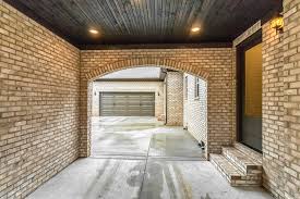 Porte Cochere Tongue And Groove Pine Ceiling Ebony Stain Brown Long Panel Garage Doors Meridian Cottonwood Br Garage Door Panels Custom Homes Porte Cochere