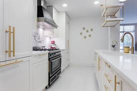 That notion disappears just as soon as they touch or hold the gleaming white doors and feel the unmistakable quality of the solid. A Kitchen With White Shaker Cabinets And Gold Brass Hardware Contemporary Kitchen Vancouver By Dimora Interiors Houzz