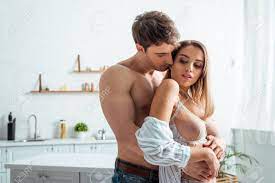 Muscular Man Hugging Sexy Woman With Big Breast Stock Photo, Picture and  Royalty Free Image. Image 139534765.