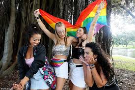 Attendees snap a selfie as they enjoy the mardi gras 2021 celebrations at the sydney cricket ground this happy reveller enjoys a drink while watching the parade, dressed in glittery gold. 313rzwjwwzwk M