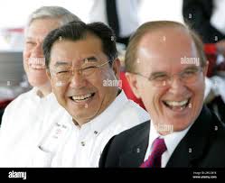 Toyota Motor Manufacturing, Texas Inc. President Hidehiko Tajima, center,  with vice president of administration Luis de la Garza, left, and county  judge Nelson Wolfe, right, share a laugh during a news conference