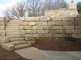 In a typical limestone wall, the weight of the limestone blocks is the only force holding the soil back. Large Block Limestone Retaining Wall But Prefer Non Curving Stairs Landscaping Retaining Walls Backyard Retaining Walls Limestone Retaining Wall
