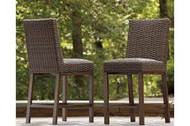 Outdoor bar stools bring comfortable and stylish seating to your outdoor bar, bistro table or outdoor kitchen counter. Paradise Trail Outdoor Bar Stool Set Of 2 Ashley Furniture Homestore