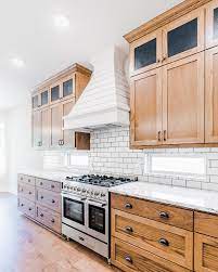 Painting them is the obvious choice, but it either costs a ton of $$ or. Modern Farmhouse Style Kitchen With Custom Oak Cabinets White Shiplap Hood And White Subway Tile Farmhouse Style Kitchen Kitchen Cabinet Styles Stained Kitchen Cabinets