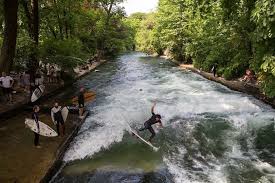A German Surfer Hanging Ten In The Eisbach River Munich With Kids Surfing Munich Surfing Waves