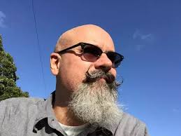 Why might some people look more attractive if hair covers their forehead?