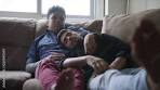 Young Gay Men Sleeping And Relaxing On Sofa At Home ...