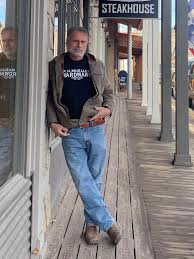 Here is Kirk Lindstrom in Downtown Dubois, Wyoming outside the Lone Buffalo  steak house showing off his new P.H. Mueller T-shirt. The shirt design was  created by artist Casey King. We still