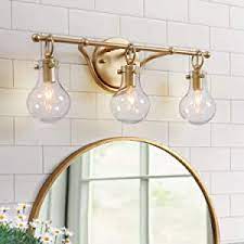 Its frame is crafted from stainless steel, and it has a round backplate and a short rod with a reversible mounting design. Ksana Gold Bathroom Light Fixtures 3 Light Vanity Light Fixtures With Clear Glass Amazon Com