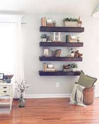 Thick Dark Stained Wood Shelves Make A Statement In A Light Colored Space Farm House Living Room Floating Shelves Living Room Wall Decor Living Room